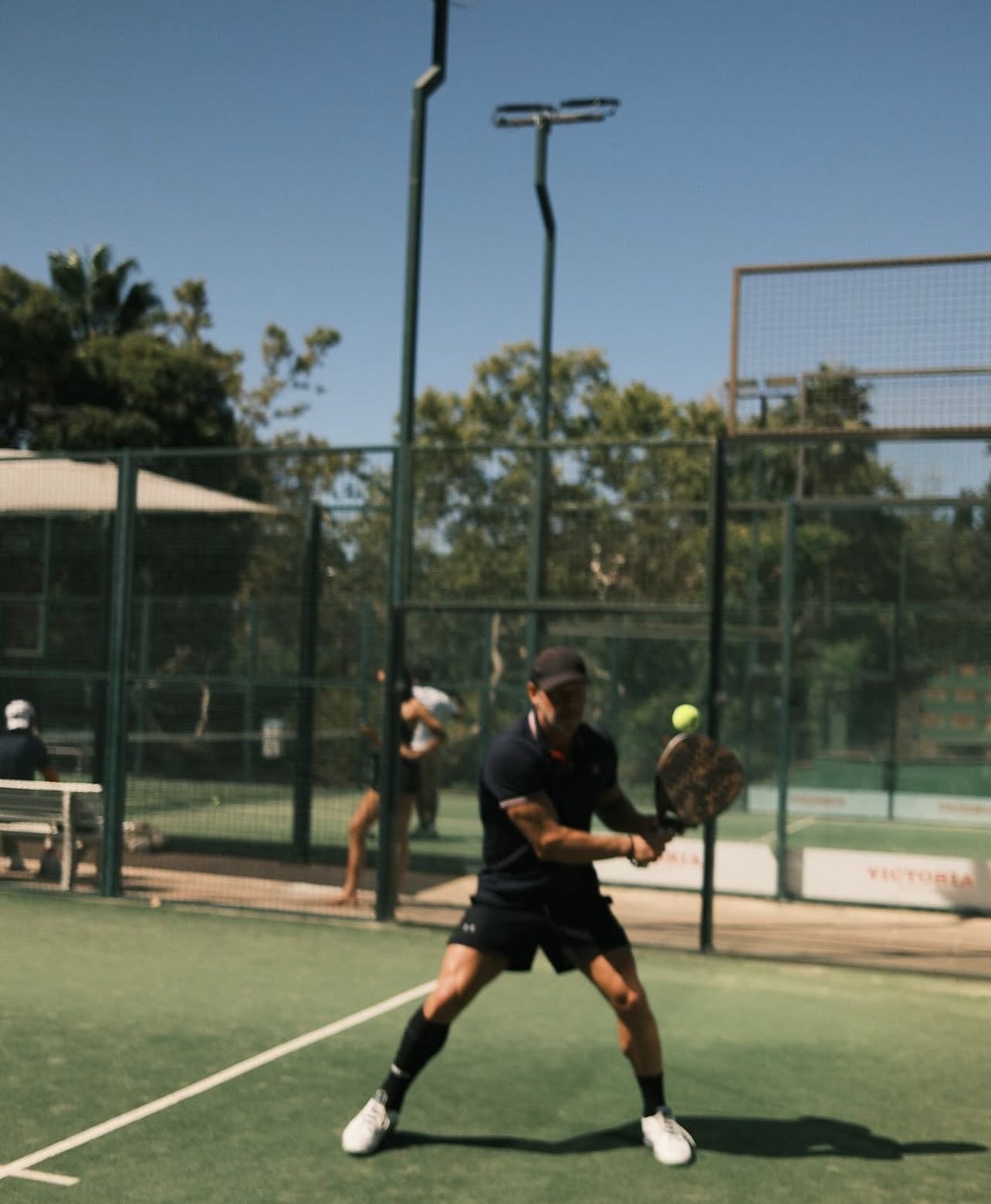 Jesús hitting a backhand volley in the sun