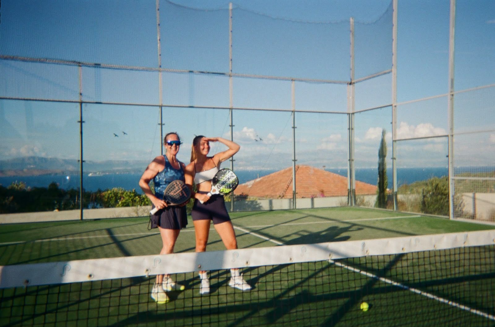 Two players smiling at the net