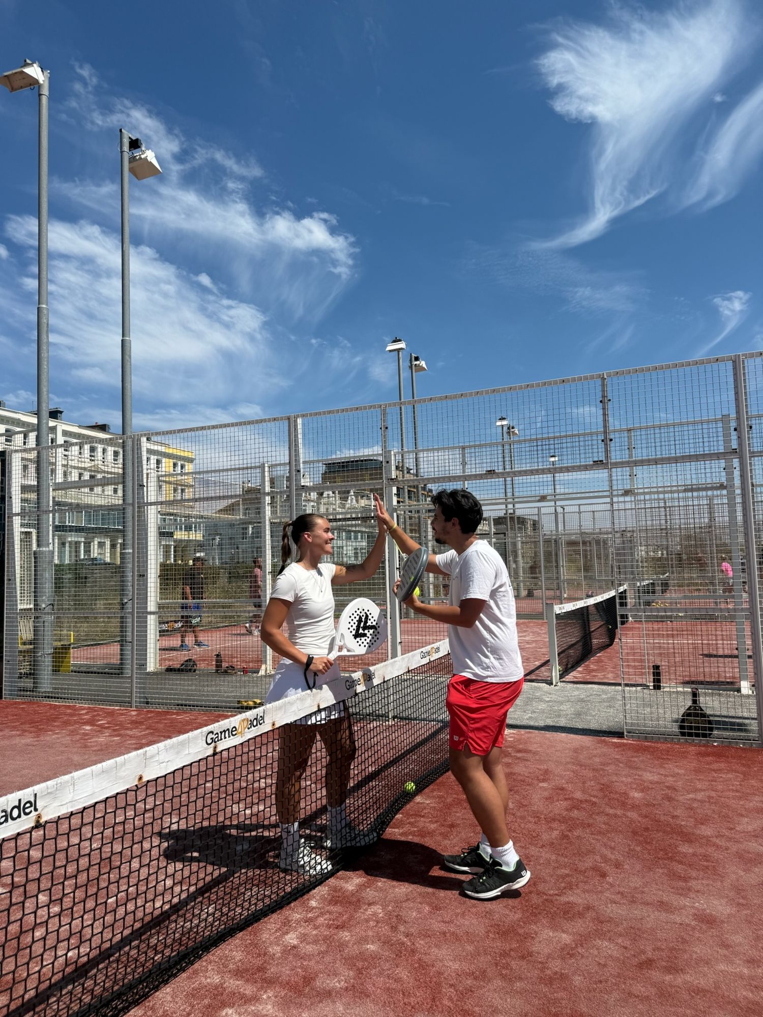 Malin and Jesús high-five over the net